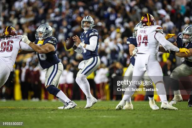 Dak Prescott of the Dallas Cowboys looks to pass against the Washington Commanders during the first half of the game at FedExField on January 7, 2024...