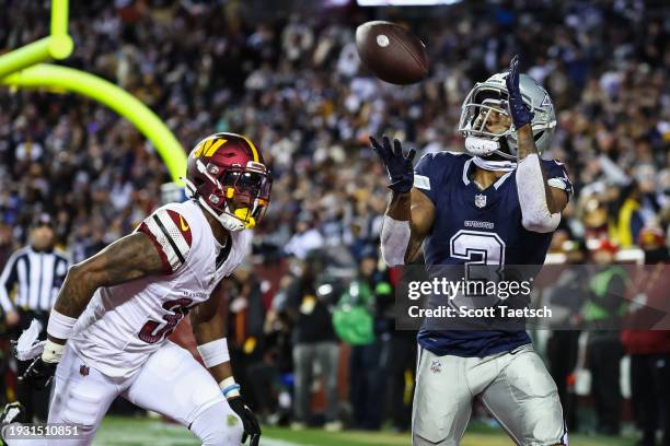 Brandin Cooks of the Dallas Cowboys catches a pass for a touchdown in front of Kyu Blu Kelly of the Washington Commanders during the second half of...