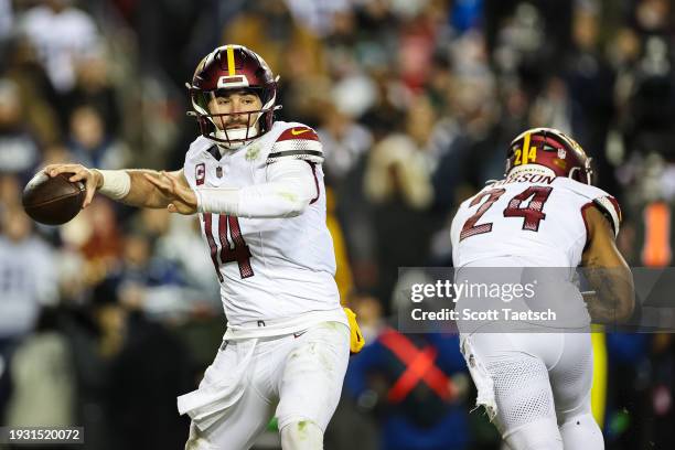 Sam Howell of the Washington Commanders attempts a pass against the Dallas Cowboys during the second half of the game at FedExField on January 7,...