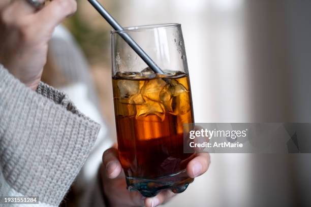 woman putting metal straw in her drink - ice cube house stock pictures, royalty-free photos & images