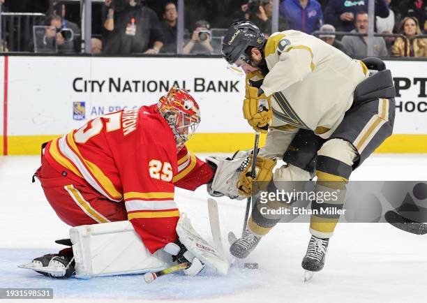 Jacob Markstrom of the Calgary Flames makes a save against Nicolas Roy of the Vegas Golden Knights in the second period of their game at T-Mobile...