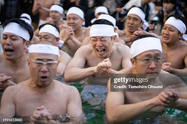 Participants bathe in ice-cold water during a Shinto ritual at Teppozu Inari Shrine on January 14, 2024 in Tokyo, Japan. The annual new year event...