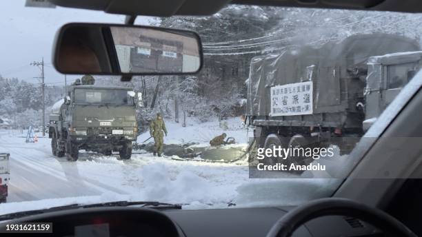 Officials work on earthquake-affected buildings and roads buried under snow in Noto Peninsula, where many earthquakes occurred in early January and...