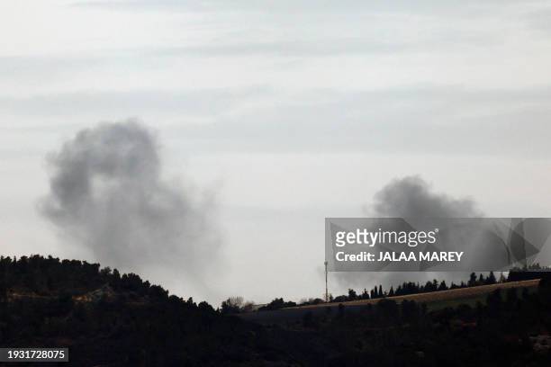 This picture taken from an Israeli position along the border with Lebanon shows smoke billowing behind the Ramim ridge in northern Israel from an...