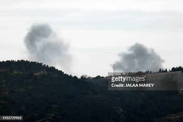 This picture taken from an Israeli position along the border with Lebanon shows smoke billowing behind the Ramim ridge from an area targeted by...