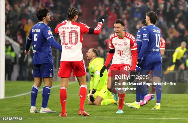 Jamal Musiala of FC Bayern München celebrates with teammate Leroy Sane after scoring his teams second goal during the Bundesliga match between FC...