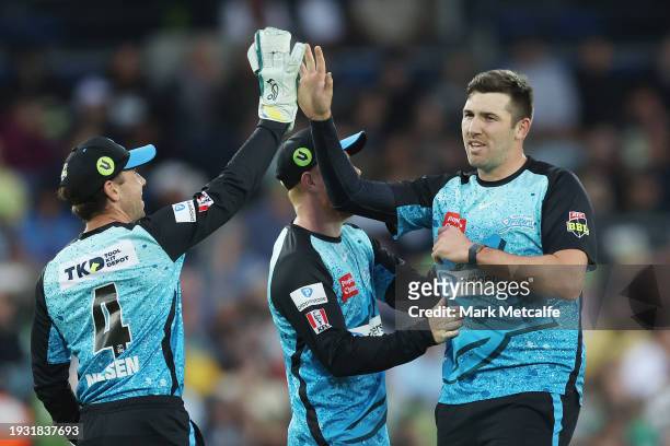Jamie Overton of the Strikers celebrates taking the wicket of Oliver Davies of the Thunder during the BBL match between Sydney Thunder and Adelaide...