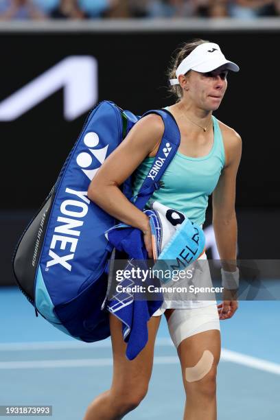 Magda Linette of Poland walks off Margaret Court Arena after retiring injured from her round one singles match against Caroline Wozniacki of Denmark...