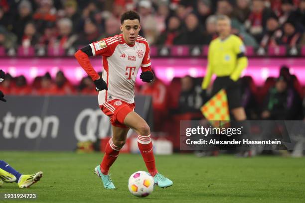 Jamal Musiala of FC Bayern München runs with the ball during the Bundesliga match between FC Bayern München and TSG Hoffenheim at Allianz Arena on...