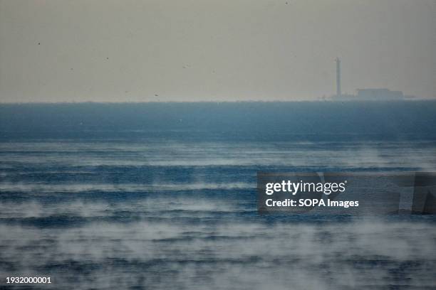 Frost smoke seen over the sea. On a very cold day in winter, the evaporation of relatively warm seawater in contact with extremely cold air quickly...