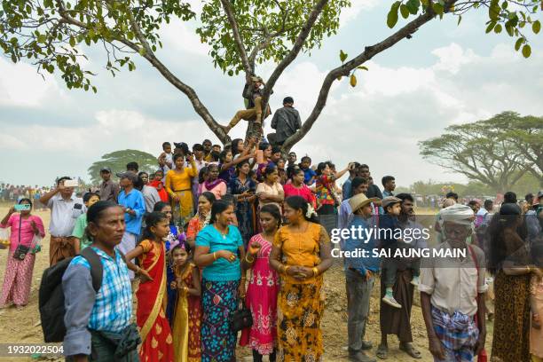 Myanmar Hindu devotees watch the annual bull taming 'Jallikattu' festival in Kyauktan township on the outskirts of Yangon on January 17, 2024.