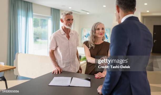 male estate agent shaking hands with man - high society stock pictures, royalty-free photos & images
