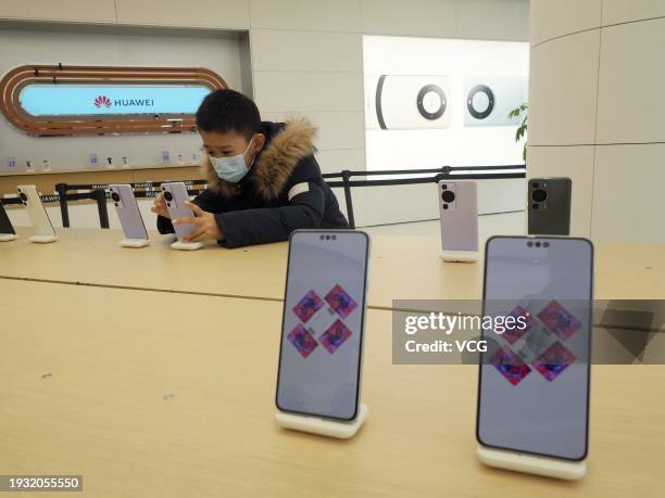 Customer tries out smartphones at Huawei's flagship store on January 13, 2024 in Beijing, China. Huawei's first flagship store in Beijing opened on...