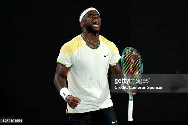 Frances Tiafoe of the United States celebrates winning set point in their round one singles match against Borna Coric of Croatia during day one of...
