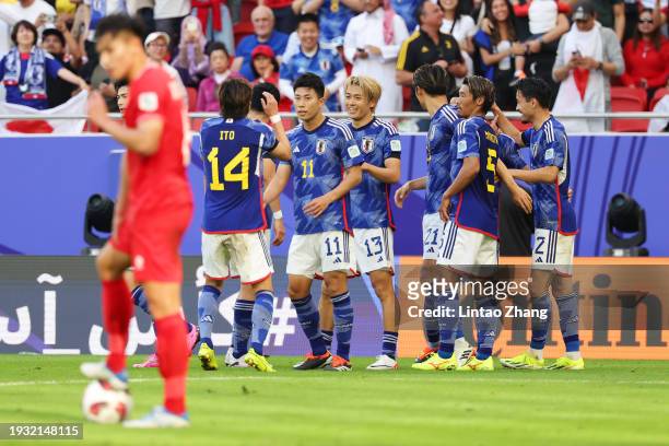 Keito Nakamura of Japan celebrates with teammates after scoring his team's third goal during the AFC Asian Cup Group D match between Japan and...