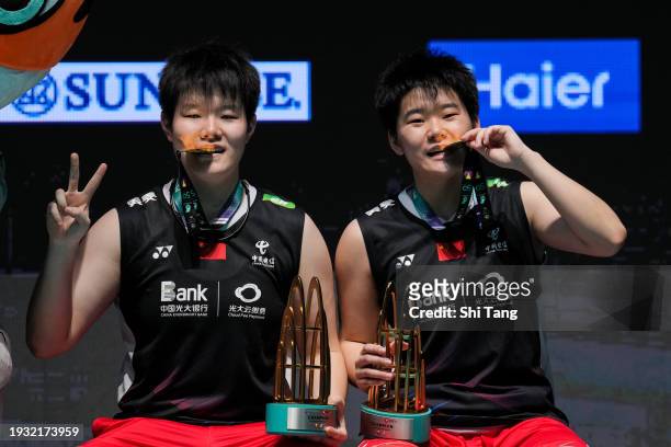Liu Shengshu and Tan Ning of China pose with their trophies on the podium after the Women's Doubles Final match against Zhang Shuxian and Zheng Yu of...