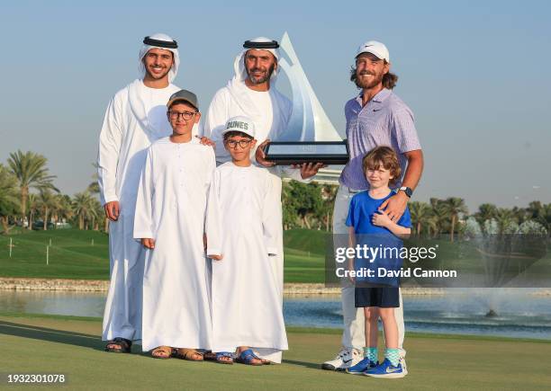 Tommy Fleetwood of England and his young son Frankie hold the Dubai Invitational Trophy with Abdulla Al Naboodah the host of the event and his three...