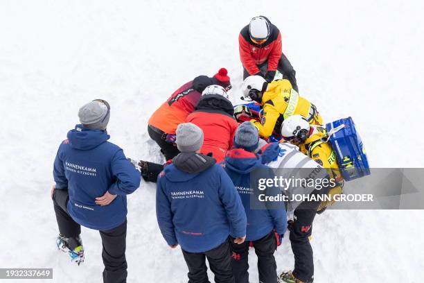 Switzerland's Remi Cuche is perpared to be airlifted by helicopter after crashing during the second training of the men's Downhill of FIS ski alpine...