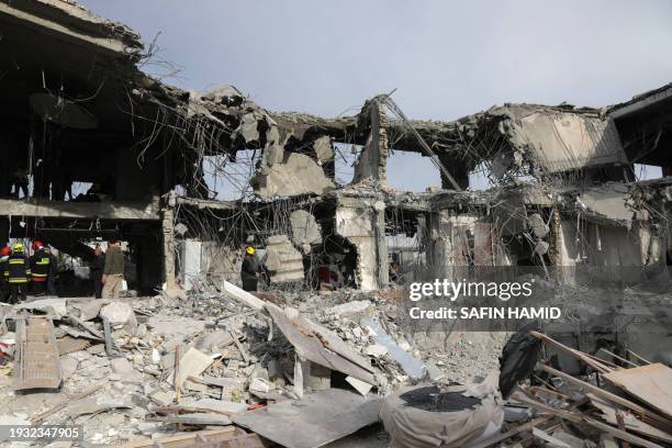 Civil defence team carry out search and rescue operations in a damaged building following a missile strike launched by Iran's Revolutionary Guard...