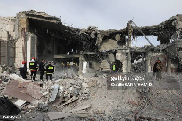 Civil defence team carries out search and rescue operations in a damaged building following a missile strike launched by Iran's Revolutionary Guard...