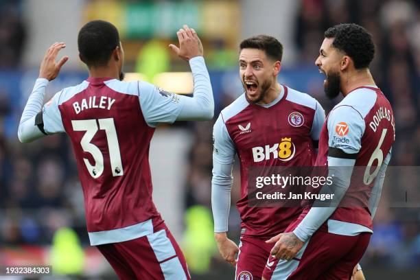 Alex Moreno of Aston Villa celebrates with teammates Leon Bailey and Douglas Luiz after scoring their team's first goal during the Premier League...