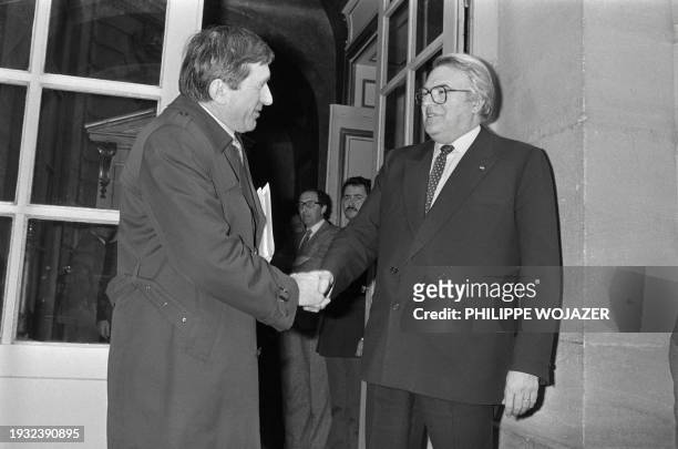 French Prime Minister Pierre Mauroy welcomes on March 6, 1983 André Lajoinie, President of the communist group at the National Assembly, at the Hôtel...