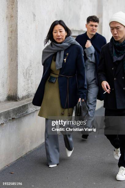 Guest wears navy blazer, grey jumper outside Prada during the Milan Fashion Week - Menswear Fall/Winter 2024-2025 on January 14, 2024 in Milan, Italy.