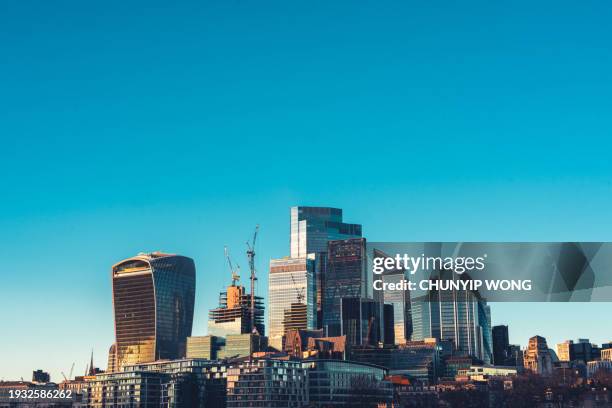 skyline of city of london with corporate office buildings of at sunset - london skyline river thames stock pictures, royalty-free photos & images