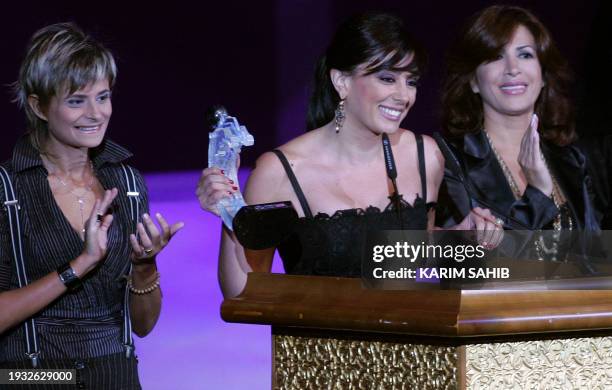 -- File picture dated October 19, 2007 shows Lebanese director Nadine Labaki accepting an award for her film 'Caramel' as cast members Joanna...