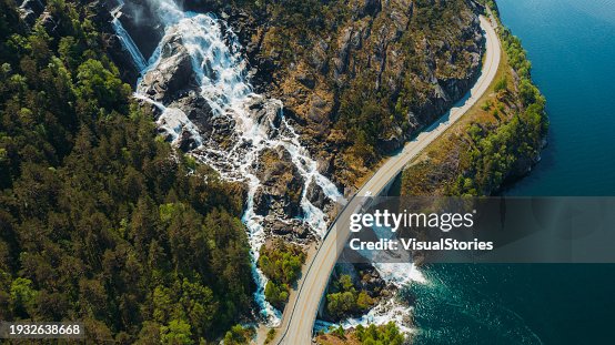 Aerial View of Truck Driving Idyllic Mountain Road Above Scenic Waterfall in Norway Aerial View of Truck Driving Idyllic Mountain Road Above Scenic Waterfall in Norway