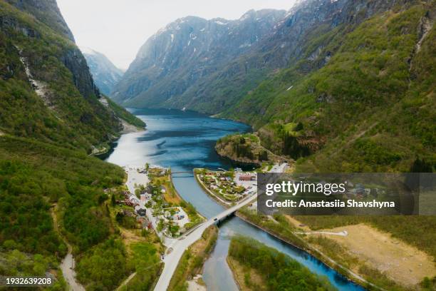 aerial view of car on road in town at idyllic mountain valley with fjord view in norway - car aerial view stock pictures, royalty-free photos & images