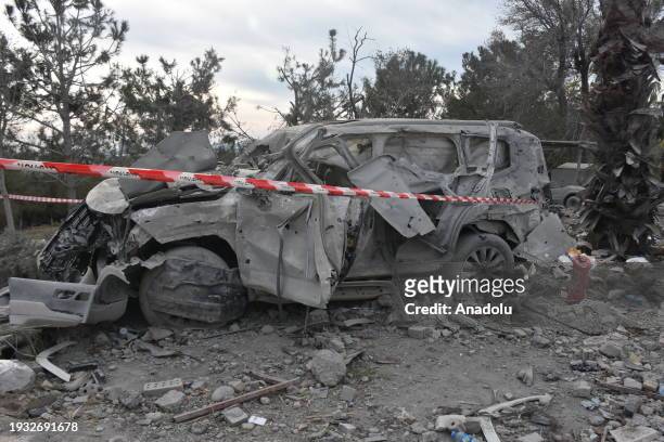 View a destroyed vehicle at the site targeted by Iran's Islamic Revolutionary Guard Corps missile attacks as search and rescue efforts continue in...