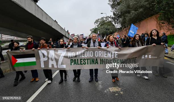 Secretary-General Isabel Camarinha marches behind a banne from the U.S Embassy to Israeli Embassy during a protest "for peace in the Middle East, for...