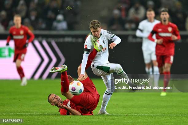 Waldemar Anton of VfB Stuttgart battles for possession with Robin Hack of Borussia Moenchengladbach during the Bundesliga match between Borussia...