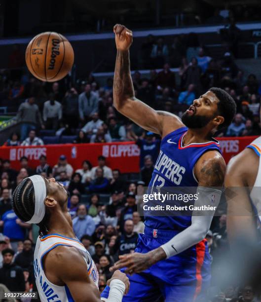 Los Angeles, CA, Tuesday, January 16, 2024 - LA Clippers forward Paul George follows through on a dunk over Oklahoma City Thunder guard Shai...