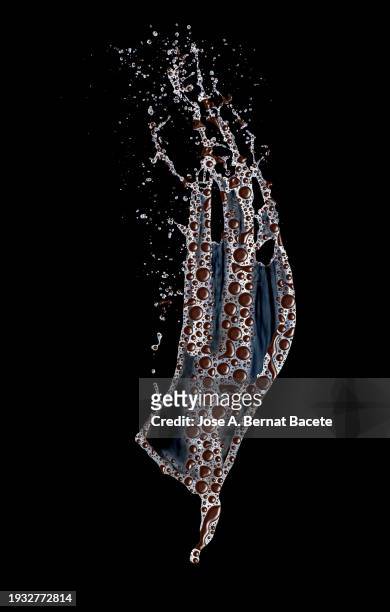 splashing a stream of milk with chocolate drops on a black background. - chocolate milk splash stock pictures, royalty-free photos & images