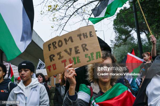 Demonstrator holds a "From the river to the sea" sign while marching from the U.S Embassy to Israeli Embassy during a protest "for peace in the...