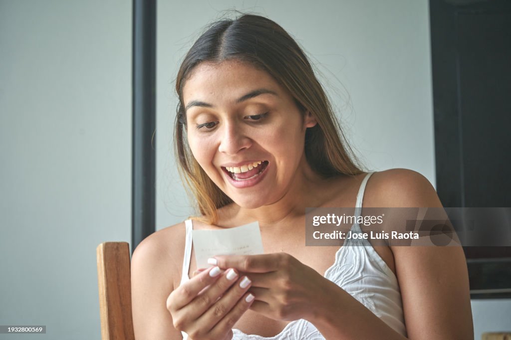 Excited Women looking at lottery ticket