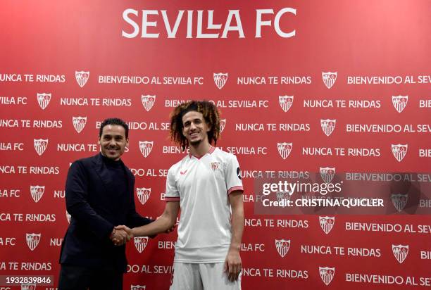 Sevilla's newly signed player Tunisian midfielder Hannibal Mejbri shakes hands with Sevilla President Jose Maria del Nido Carrasco, during his...