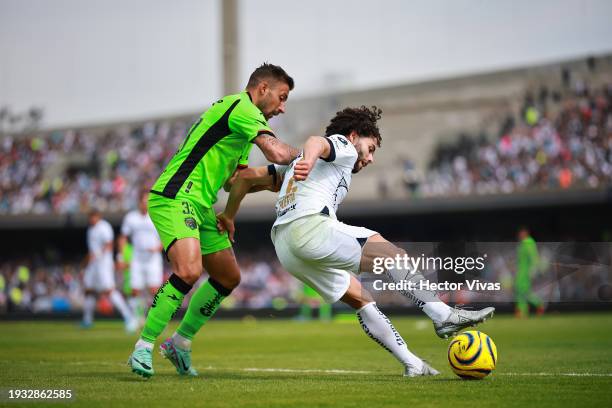 Aitor Garcia of FC Juarez battles for possession with Cesar Huerta of Pumas UNAM during the 1st round match between Pumas UNAM and FC Juarez as part...