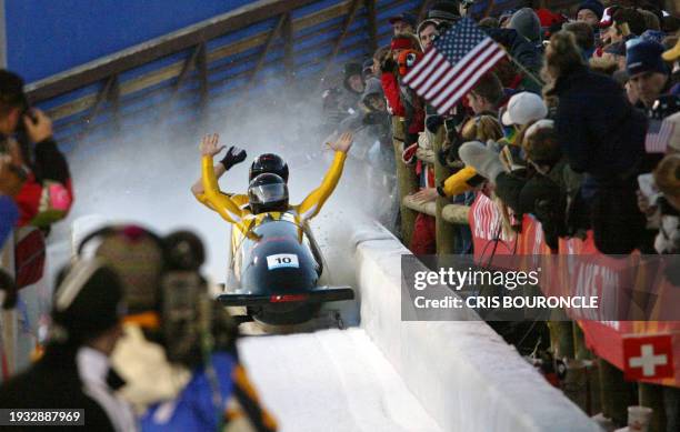 Swiss bobsleigh pilot Christian Reich and his teammate Steve Anderhub celebrate on bob SUI-1at the end of their two-man bobsleigh race during the...