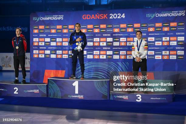 Niall Treacy of Great Britain , Pietro Sighel of Italy and Stijn Desmet of Belgium pose on podium after Men`s 1000m medal ceremony during the ISU...