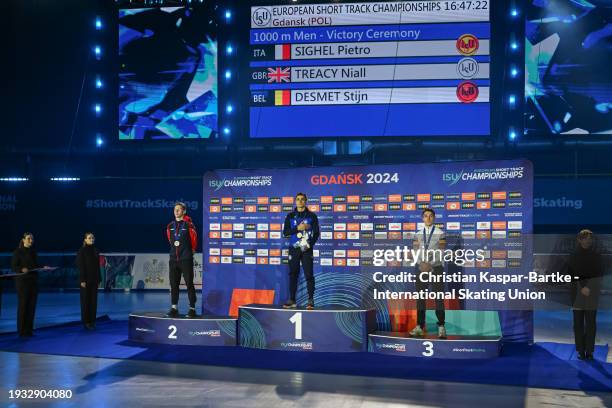 Niall Treacy of Great Britain , Pietro Sighel of Italy and Stijn Desmet of Belgium pose on podium after Men`s 1000m medal ceremony during the ISU...