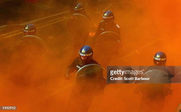 British police officers participate in a mock riot demonstration at the Metropolitan Police Specialist Training Centre April 15, 2003 in Kent,...