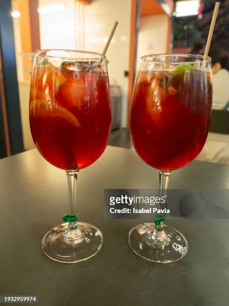 two glasses of sangria on table - apfelpunsch stock-fotos und bilder