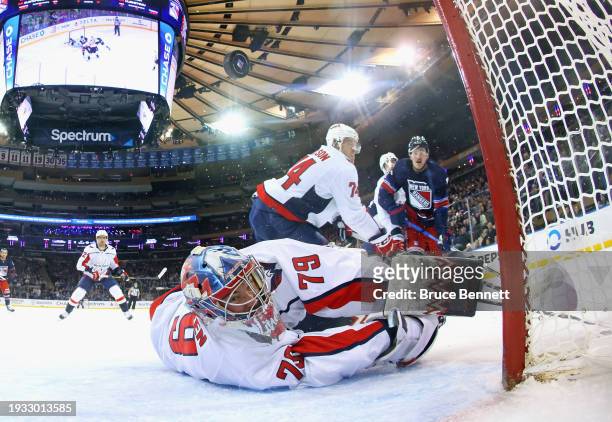 Alexis Lafreniere of the New York Rangers pops the puck over Charlie Lindgren of the Washington Capitals during the first period at Madison Square...