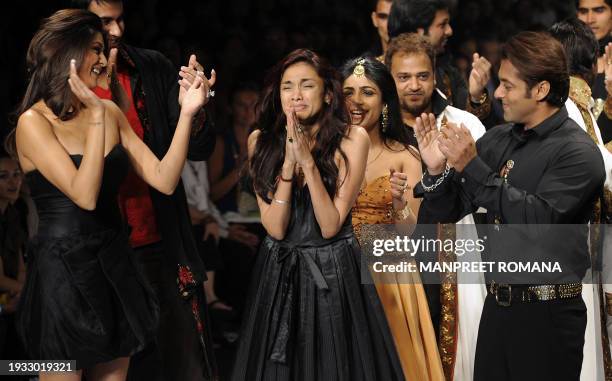 Indian actress Susmita Sen and Indian actor Salman Khan applaud Indian designer Sanjana Jon during her show at the Wills India Fashion Week Spring...