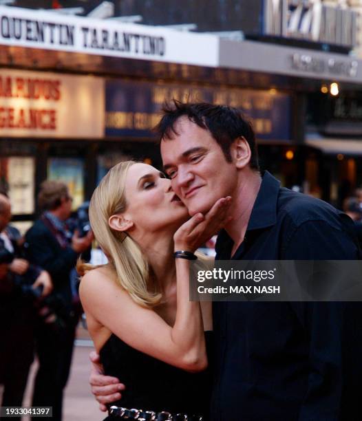 Film director Quentin Tarantino gets a kiss from his leading lady, German actress Diane Kruger after arriving in London's Leicester Square on July 23...