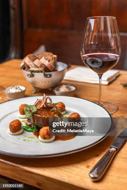 beef deer steak filet with fried sweetbread and gravy served with red wine at michelin star gourmet restaurant - veal sweetbreads stock pictures, royalty-free photos & images