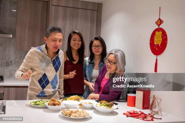 family shares meal together at new years - 25 30 years old asian stock-fotos und bilder